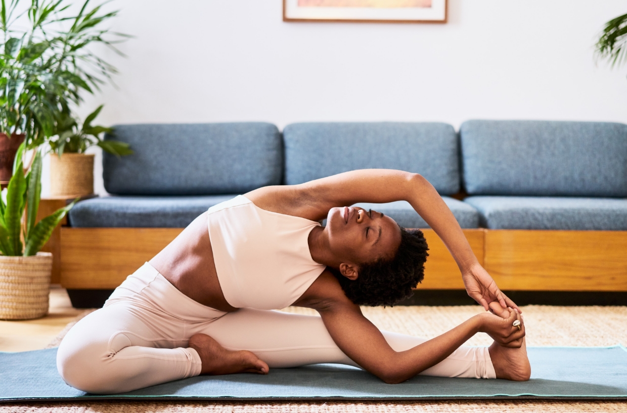 Woman doing yoga in living room