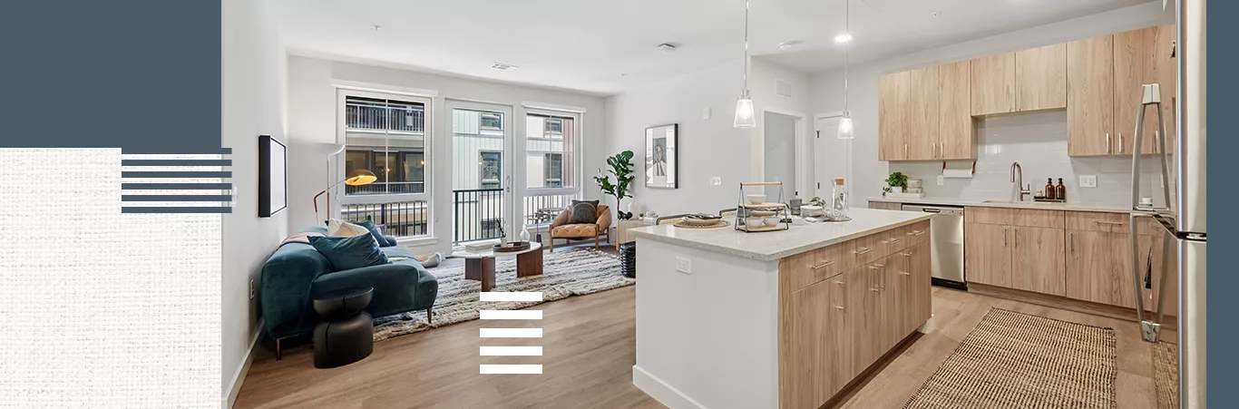 An open-concept living apartment with white walls, light-color wood cabinets and flooring, and large windows, on textured white background with blue and white accents.